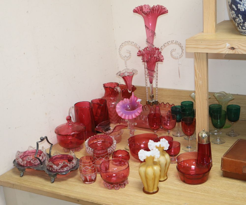 A Victorian cranberry glass epergne, height 56cm, a set of green glasses, two vaseline vases, etc